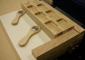 The final screw-down version – a little smaller and lower profile, with a smaller hub and hole sized for a screw - had no problem securing these solid wood parts for edge notching.  The entire jig took only minutes to staple together and is itself being held to the table with the vacuum system.